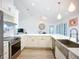 Bright, open kitchen features white cabinets, stainless steel appliances, and a large island at 27466 Tierra Del Fuego Cir, Punta Gorda, FL 33983