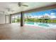 Screened lanai with fans overlooks sparkling pool, perfect for relaxing and entertaining outdoors with beautiful landscaping at 27466 Tierra Del Fuego Cir, Punta Gorda, FL 33983