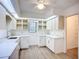 Laundry room has bright lights, wood-look flooring, and bright open cabinets at 27466 Tierra Del Fuego Cir, Punta Gorda, FL 33983