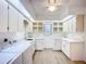 Bright laundry room with white cabinets, sink, and washer/dryer at 27466 Tierra Del Fuego Cir, Punta Gorda, FL 33983