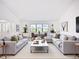 Spacious living area featuring ample seating, large windows, and modern decor at 27466 Tierra Del Fuego Cir, Punta Gorda, FL 33983