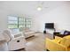 Bright living room featuring wood-look floors, a large window, and comfortable seating at 27466 Tierra Del Fuego Cir, Punta Gorda, FL 33983