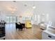 Open-concept living room with a kitchen island, French doors, and hardwood floors and vaulted ceilings for a bright and airy feel at 27466 Tierra Del Fuego Cir, Punta Gorda, FL 33983