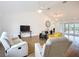 Spacious living room features vaulted ceilings, modern furniture, and double doors at 27466 Tierra Del Fuego Cir, Punta Gorda, FL 33983