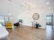 Open-concept living room with hardwood floors, decor, vaulted ceilings, furniture and access to the kitchen at 27466 Tierra Del Fuego Cir, Punta Gorda, FL 33983