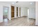 Neutral living room features built-in storage with open doors and durable flooring at 27466 Tierra Del Fuego Cir, Punta Gorda, FL 33983