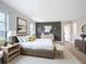 Stylish primary bedroom featuring a comfortable bed, elegant decor, and ample natural light at 27466 Tierra Del Fuego Cir, Punta Gorda, FL 33983