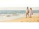 A couple enjoying a walk on the beach at 2797 Marrakesh Ln, Sarasota, FL 34234