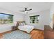Cozy bedroom features bright windows, a ceiling fan, and beautiful hard wood floors at 2902 W Lemon St, Tampa, FL 33609