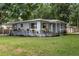 Attractive single-story home featuring a welcoming front porch and lush landscaping at 2902 W Lemon St, Tampa, FL 33609
