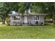 Charming single-story home features a cozy front porch and lush green lawn at 2902 W Lemon St, Tampa, FL 33609