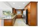 Modern kitchen features wooden cabinets, granite countertops, and stainless steel appliances at 2902 W Lemon St, Tampa, FL 33609