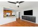 Bright living room features an open kitchen with stainless steel appliances and sleek dark wood media center at 2902 W Lemon St, Tampa, FL 33609
