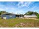 The home's exterior featuring an enclosed back porch and a grassy yard at 3204 Dodge St, Tampa, FL 33605