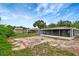 Wide backyard showcasing the home's exterior, a shed, and ample space for activities at 3204 Dodge St, Tampa, FL 33605