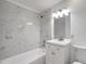 Newly renovated bathroom with stylish marble tiling, updated fixtures, and vanity at 3204 Dodge St, Tampa, FL 33605