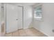 Neutral bedroom has tile floors, a window with blinds and a closet at 3204 Dodge St, Tampa, FL 33605