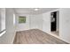 Bedroom with modern floors, fresh white paint, and views of the neighborhood at 3204 Dodge St, Tampa, FL 33605