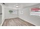 Bedroom with wood-look floors and two windows allowing natural light at 3204 Dodge St, Tampa, FL 33605