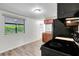 Efficient kitchen with laminate floors, wood cabinets, and black appliances at 3204 Dodge St, Tampa, FL 33605
