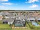 Expansive aerial view of a home showcasing a screened pool and backyard oasis in a vibrant residential neighborhood at 32490 Tree Of Life Ave, Wesley Chapel, FL 33543