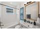 Modern bathroom featuring marble sink, tub and shower combination, and artwork at 32490 Tree Of Life Ave, Wesley Chapel, FL 33543
