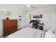Bedroom with comfortable bed, desk, dresser, and modern decor, perfect for relaxation at 32490 Tree Of Life Ave, Wesley Chapel, FL 33543