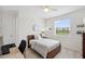 Bright bedroom features a comfy bed, sleek desk, and a scenic view from the window at 32490 Tree Of Life Ave, Wesley Chapel, FL 33543