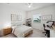 Bright, minimalist bedroom with wood-look floors, contemporary décor, and lots of natural light at 32490 Tree Of Life Ave, Wesley Chapel, FL 33543