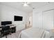 Bedroom featuring a neutral color palette, ceiling fan, desk, and closet at 32490 Tree Of Life Ave, Wesley Chapel, FL 33543