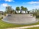 A stone waterfall feature at the community entrance, surrounded by lush greenery and landscaping at 32490 Tree Of Life Ave, Wesley Chapel, FL 33543