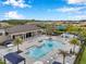 An elevated view of community pool featuring palm trees, sunbeds, shade structures, and splash pad for  at 32490 Tree Of Life Ave, Wesley Chapel, FL 33543
