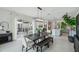 Dining area with stylish lighting, modern furniture, and a view of the outdoor space at 32490 Tree Of Life Ave, Wesley Chapel, FL 33543