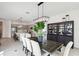 Open concept dining room and kitchen with modern lighting and finishes at 32490 Tree Of Life Ave, Wesley Chapel, FL 33543