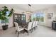 Bright dining room featuring modern light fixture, large windows, and a stylish cabinet with glass doors at 32490 Tree Of Life Ave, Wesley Chapel, FL 33543