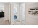 The hallway is lined with neutral walls and frames the bathroom, living spaces, and bedrooms at 32490 Tree Of Life Ave, Wesley Chapel, FL 33543