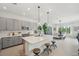 A modern kitchen features sleek gray cabinets, stainless steel appliances, and a center island with seating at 32490 Tree Of Life Ave, Wesley Chapel, FL 33543