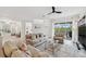 Bright living room with neutral decor, comfortable seating, and large windows offering pool views at 32490 Tree Of Life Ave, Wesley Chapel, FL 33543
