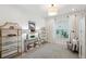 Bright living area with contemporary shelving, stylish decor, and a view into the hallway and other areas of the home at 32490 Tree Of Life Ave, Wesley Chapel, FL 33543