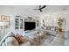 Inviting living room with stylish decor, a large entertainment center, and comfortable couches at 32490 Tree Of Life Ave, Wesley Chapel, FL 33543