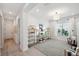 Bright living area with contemporary shelving, stylish decor, and a view into the hallway and other areas of the home at 32490 Tree Of Life Ave, Wesley Chapel, FL 33543