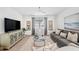 Inviting living room with stylish seating, modern TV, and elegant decor at 32490 Tree Of Life Ave, Wesley Chapel, FL 33543