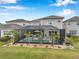 Aerial view of screened-in pool with landscaping in backyard at 32490 Tree Of Life Ave, Wesley Chapel, FL 33543