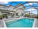 Inviting pool area with a spacious patio, comfortable seating, and screened enclosure at 32490 Tree Of Life Ave, Wesley Chapel, FL 33543