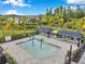 Community splash pad with sun loungers, cabanas and mature landscaping at 32490 Tree Of Life Ave, Wesley Chapel, FL 33543