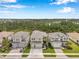 Street view of three, two-story homes with landscaped yards and driveways at 32490 Tree Of Life Ave, Wesley Chapel, FL 33543