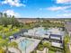 Aerial view of a community pool with splash pad, lounge chairs, and landscaping at 32490 Tree Of Life Ave, Wesley Chapel, FL 33543