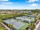Aerial shot of tennis and pickleball courts within a residential community surrounded by trees and landscaping at 32490 Tree Of Life Ave, Wesley Chapel, FL 33543
