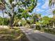 Street view of the property, showcasing mature trees and the serene neighborhood atmosphere at 4210 Garden Ln, Tampa, FL 33610