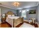 Bedroom with hardwood floors, gold bed frame, overhead light, and view out the window at 4742 13Th N Ave, St Petersburg, FL 33713